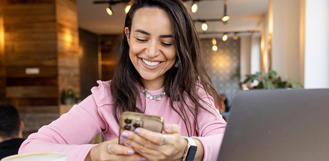 smiling woman looking at phone